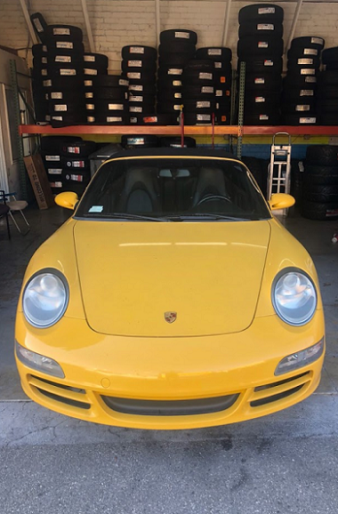 Yellow Porsche with tires